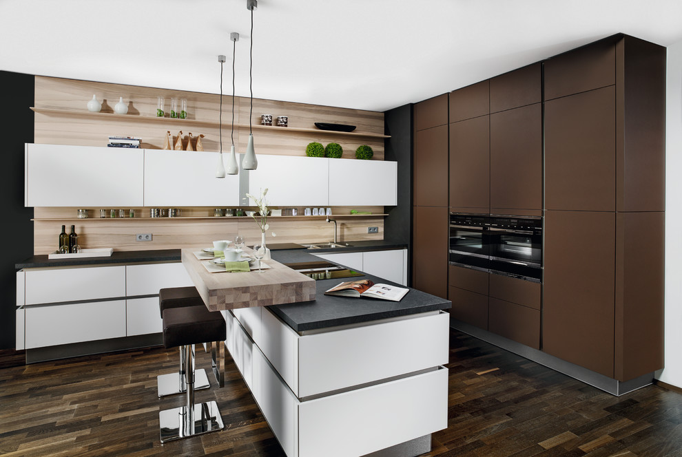 Design ideas for a small contemporary l-shaped kitchen/diner in Miami with a built-in sink, flat-panel cabinets, white cabinets, laminate countertops, brown splashback, black appliances, dark hardwood flooring and a breakfast bar.