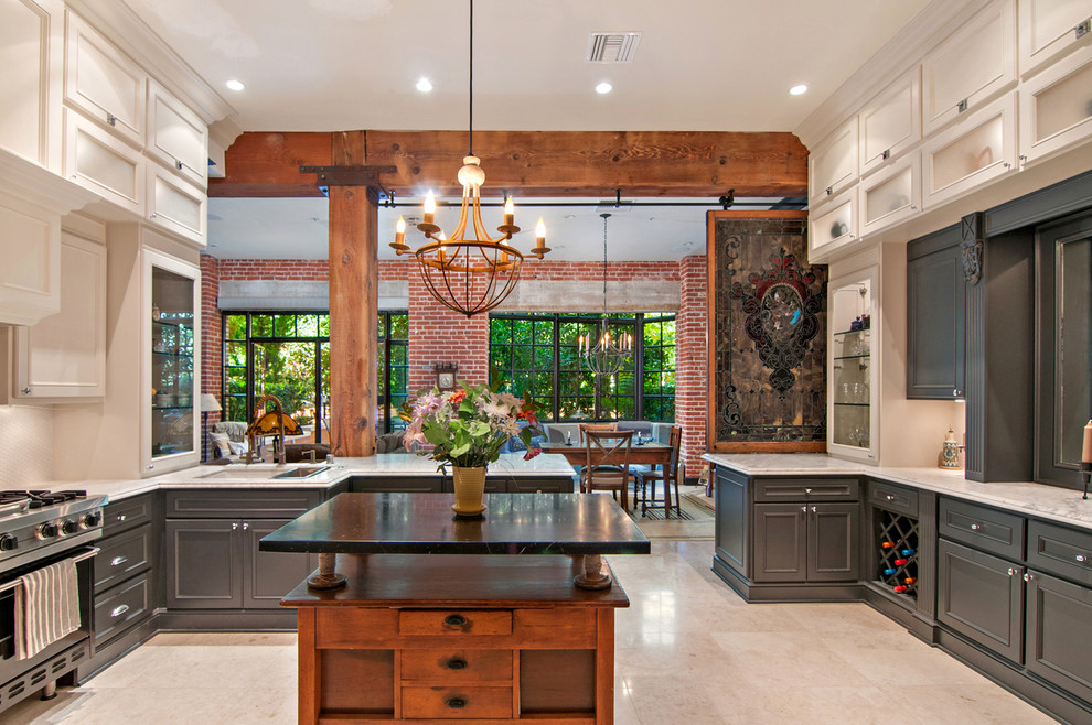 Eat-in kitchen - large craftsman marble floor eat-in kitchen idea in Los Angeles with an undermount sink, raised-panel cabinets, white cabinets, marble countertops, white backsplash, mosaic tile backsplash, stainless steel appliances and an island
