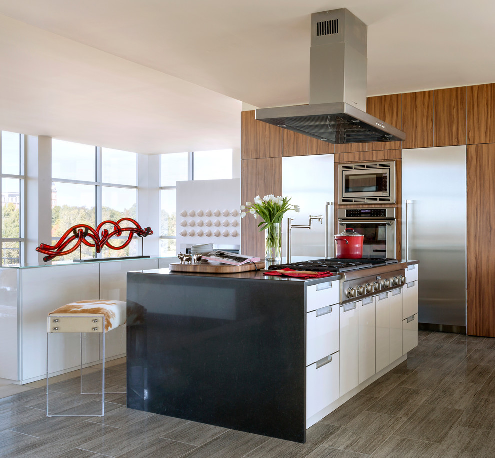 This is an example of a large contemporary kitchen/diner in Other with flat-panel cabinets, engineered stone countertops, stainless steel appliances, multiple islands, a submerged sink, white cabinets, porcelain flooring and beige floors.