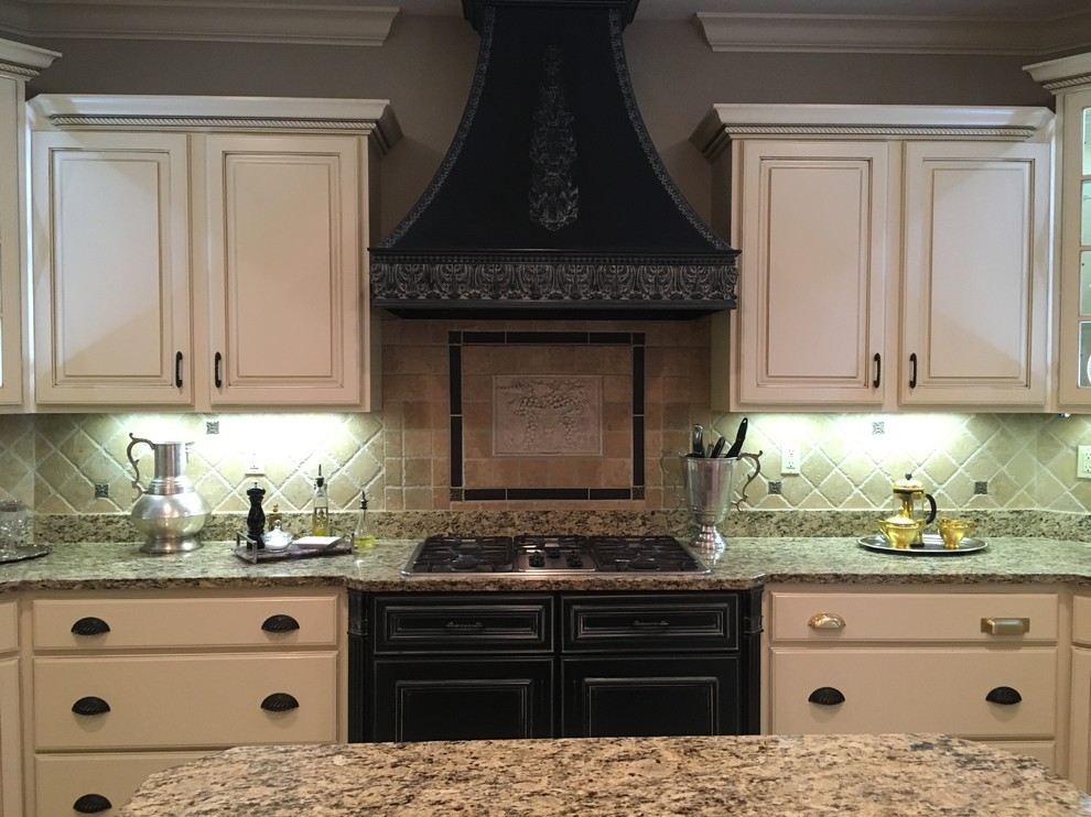 Example of a mid-sized transitional u-shaped ceramic tile and beige floor open concept kitchen design in Other with a double-bowl sink, raised-panel cabinets, light wood cabinets, granite countertops, beige backsplash, travertine backsplash, stainless steel appliances and an island