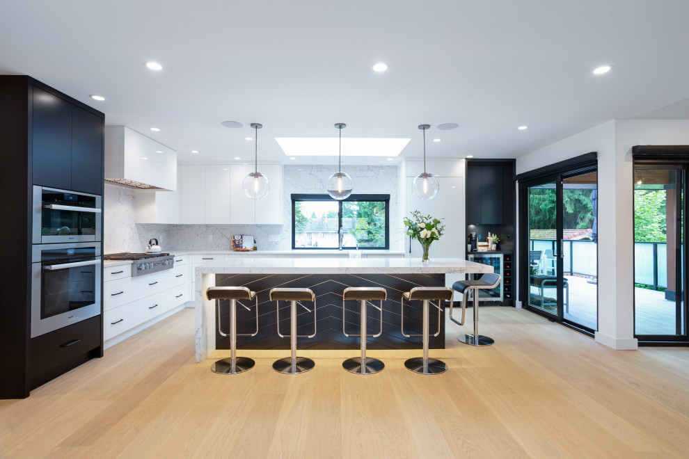 Kitchen - large contemporary l-shaped light wood floor and beige floor kitchen idea in Vancouver with quartz countertops, flat-panel cabinets, white cabinets, white backsplash, stone slab backsplash, stainless steel appliances, an island and white countertops