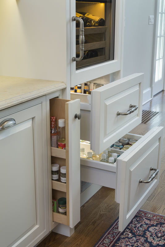 Expansive traditional galley kitchen/diner in Jacksonville with raised-panel cabinets, white cabinets, medium hardwood flooring, multi-coloured splashback, an island, limestone worktops, brown floors, integrated appliances and beige worktops.