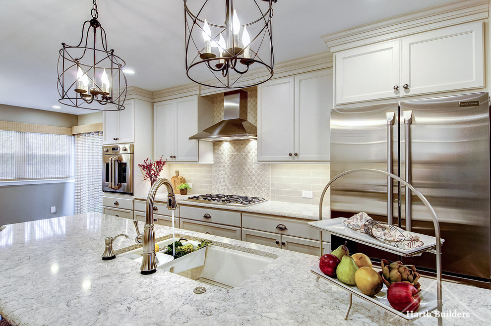 Mid-sized transitional galley medium tone wood floor eat-in kitchen photo in Philadelphia with an undermount sink, recessed-panel cabinets, white cabinets, quartz countertops, beige backsplash, glass tile backsplash, stainless steel appliances and an island