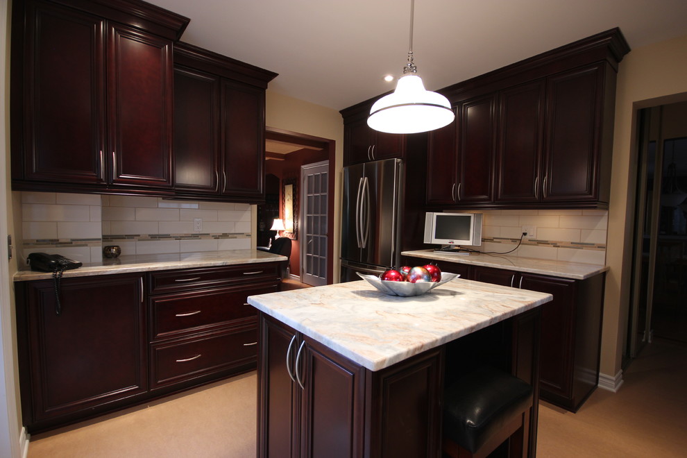 Inspiration for a mid-sized timeless u-shaped linoleum floor enclosed kitchen remodel in Ottawa with an undermount sink, raised-panel cabinets, dark wood cabinets, granite countertops, beige backsplash, glass tile backsplash, stainless steel appliances and an island