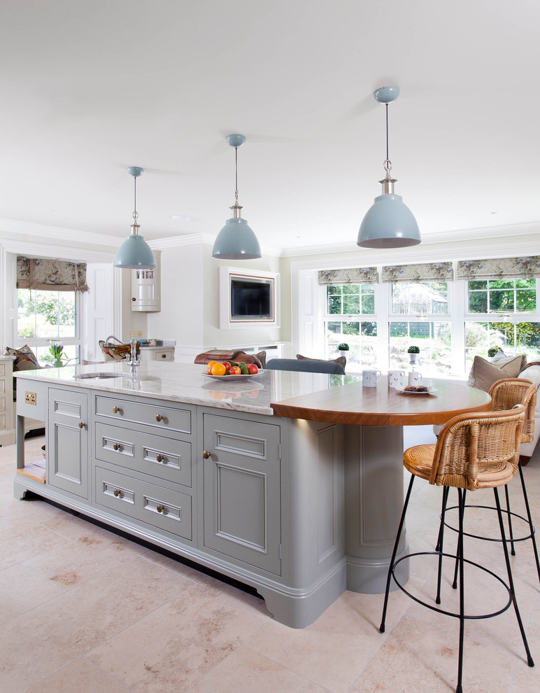 This is an example of a large rural l-shaped open plan kitchen in Belfast with a submerged sink, beaded cabinets, blue cabinets, quartz worktops, white splashback, ceramic splashback, integrated appliances, ceramic flooring, an island and grey floors.