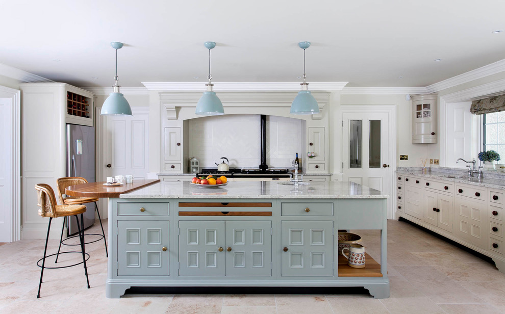 Large farmhouse l-shaped open plan kitchen in Belfast with a submerged sink, beaded cabinets, blue cabinets, quartz worktops, white splashback, ceramic splashback, integrated appliances, ceramic flooring, an island and grey floors.