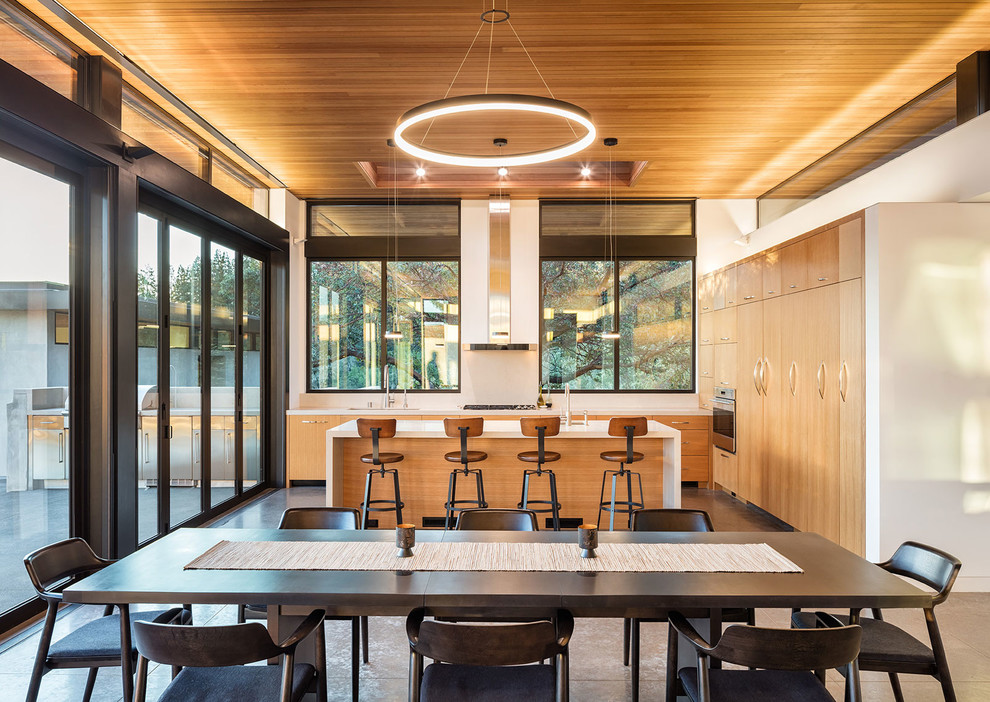 Idée de décoration pour une salle à manger ouverte sur le salon design avec sol en béton ciré et un sol gris.