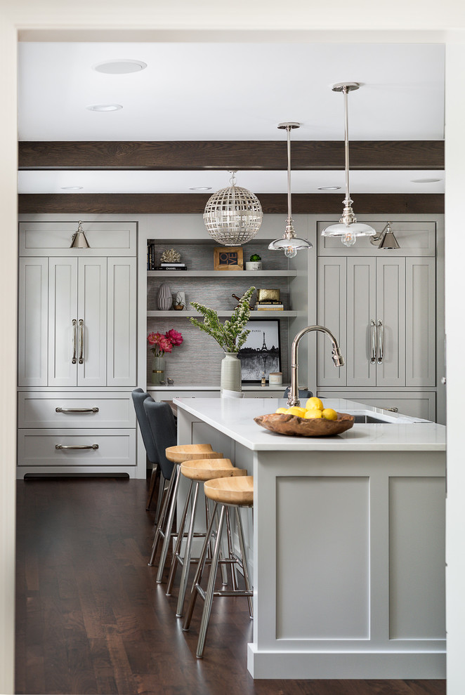Mid-sized transitional dark wood floor and brown floor eat-in kitchen photo in Chicago with an island, white countertops, beaded inset cabinets, gray cabinets, quartz countertops, white backsplash and paneled appliances