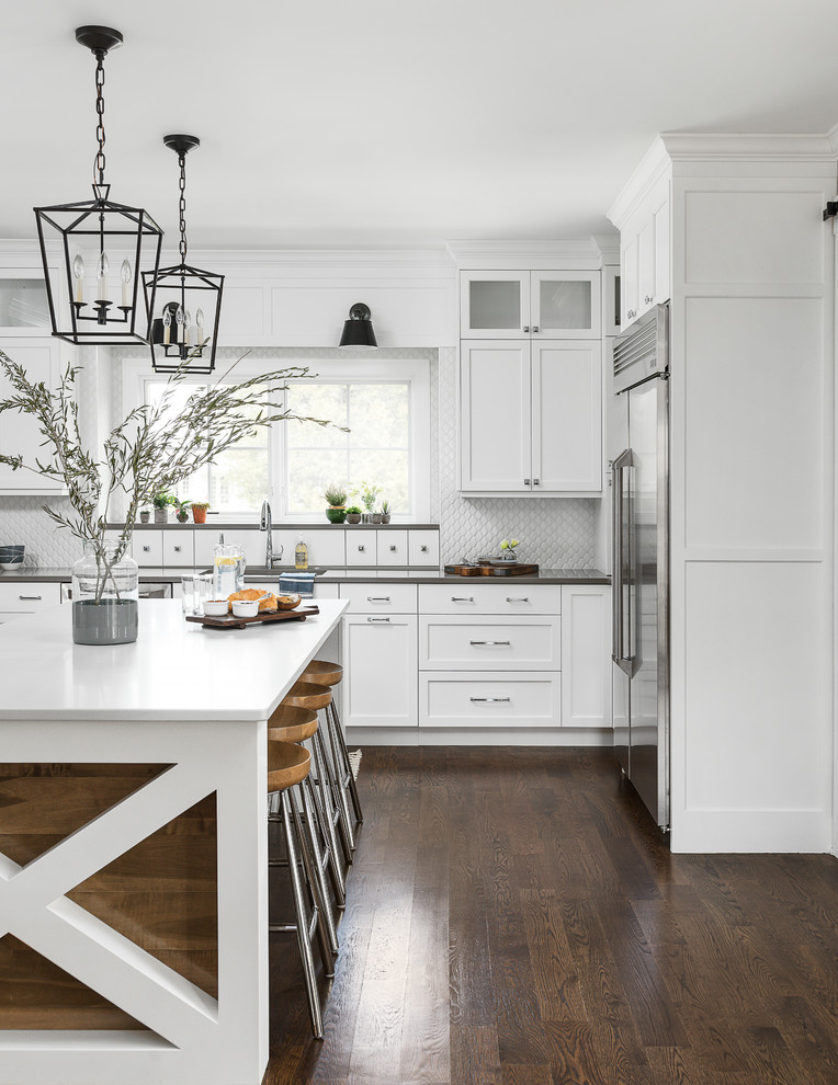 Inspiration for a large coastal medium tone wood floor and brown floor eat-in kitchen remodel in Chicago with an undermount sink, beaded inset cabinets, white cabinets, quartz countertops, white backsplash, ceramic backsplash, stainless steel appliances, an island and white countertops