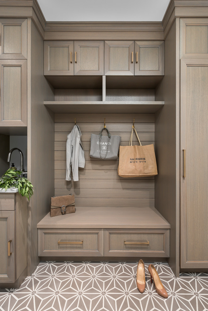 Enclosed kitchen - mid-sized transitional medium tone wood floor and brown floor enclosed kitchen idea in Chicago with a farmhouse sink, recessed-panel cabinets, gray cabinets, quartzite countertops, gray backsplash, stone slab backsplash, paneled appliances, an island and gray countertops