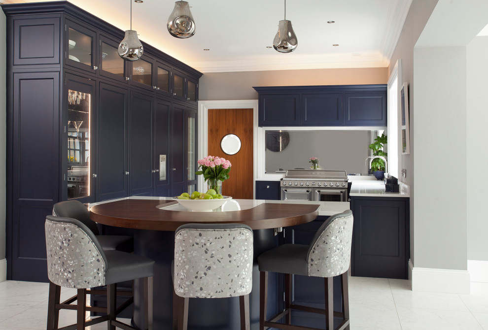 Inspiration for a large classic u-shaped kitchen/diner in Dublin with a belfast sink, beaded cabinets, blue cabinets, quartz worktops, metallic splashback, mirror splashback, stainless steel appliances, ceramic flooring, an island, white floors and white worktops.