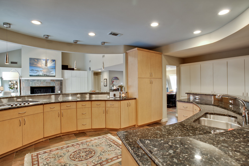 Example of a large classic l-shaped travertine floor and multicolored floor kitchen pantry design in Dallas with an undermount sink, flat-panel cabinets, light wood cabinets, granite countertops, beige backsplash, stainless steel appliances and an island