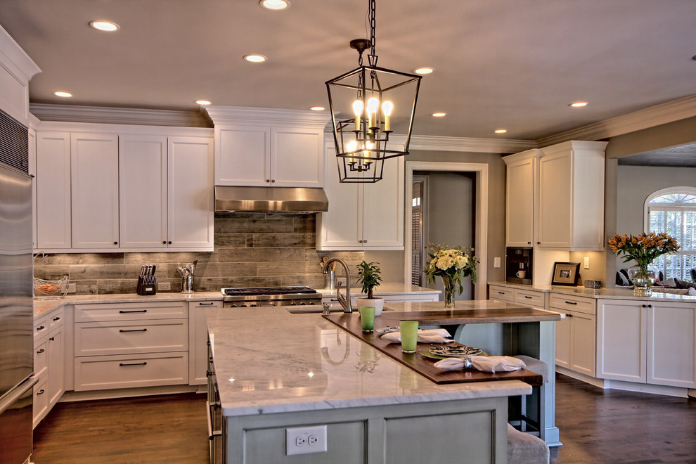 Photo of a classic kitchen in Atlanta with a single-bowl sink, shaker cabinets, white cabinets, marble worktops, porcelain splashback, stainless steel appliances and an island.