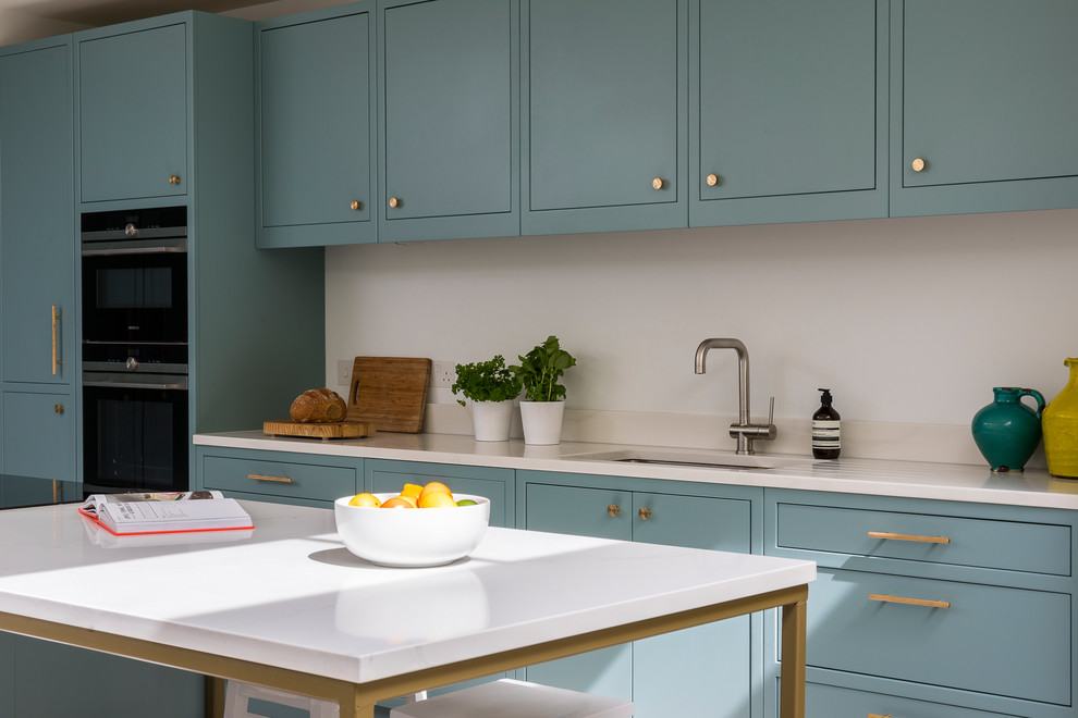 This is an example of a contemporary open plan kitchen in London with an island.