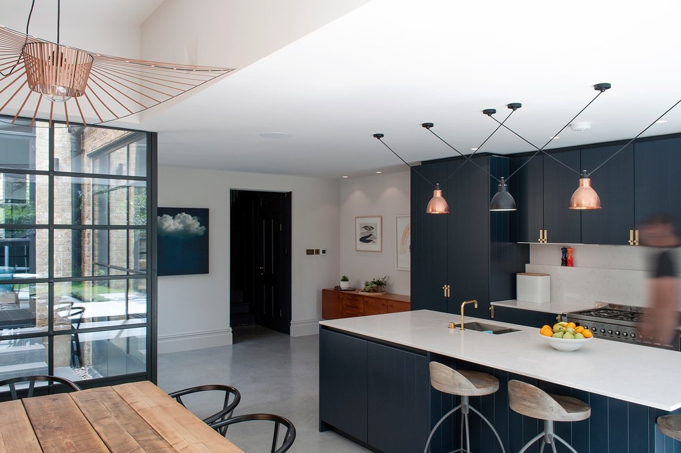 This is an example of a medium sized modern kitchen in London.