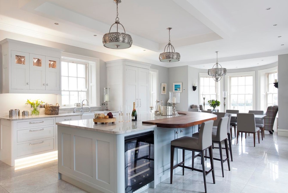 Inspiration for an expansive classic l-shaped open plan kitchen in Other with a belfast sink, shaker cabinets, blue cabinets, marble worktops, grey splashback, stone slab splashback, black appliances, ceramic flooring and an island.