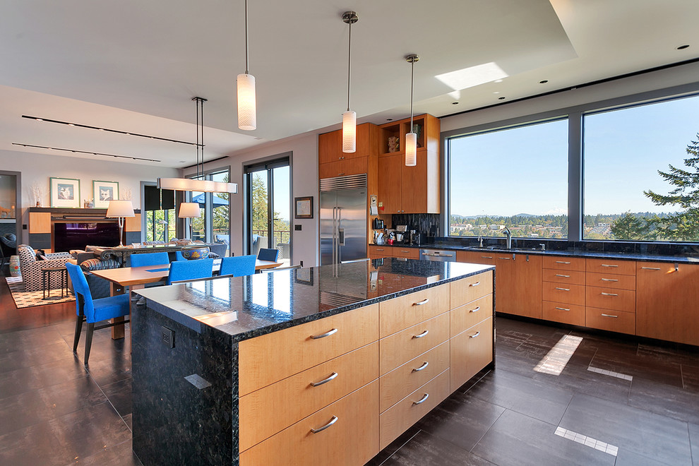 Eat-in kitchen - large contemporary u-shaped ceramic tile and gray floor eat-in kitchen idea in Portland with a farmhouse sink, flat-panel cabinets, brown cabinets, granite countertops, black backsplash, stone slab backsplash, stainless steel appliances and an island