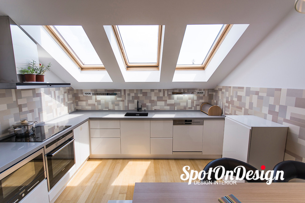Inspiration for a small contemporary l-shaped enclosed kitchen in Other with a single-bowl sink, flat-panel cabinets, white cabinets, laminate countertops, multi-coloured splashback, ceramic splashback and light hardwood flooring.