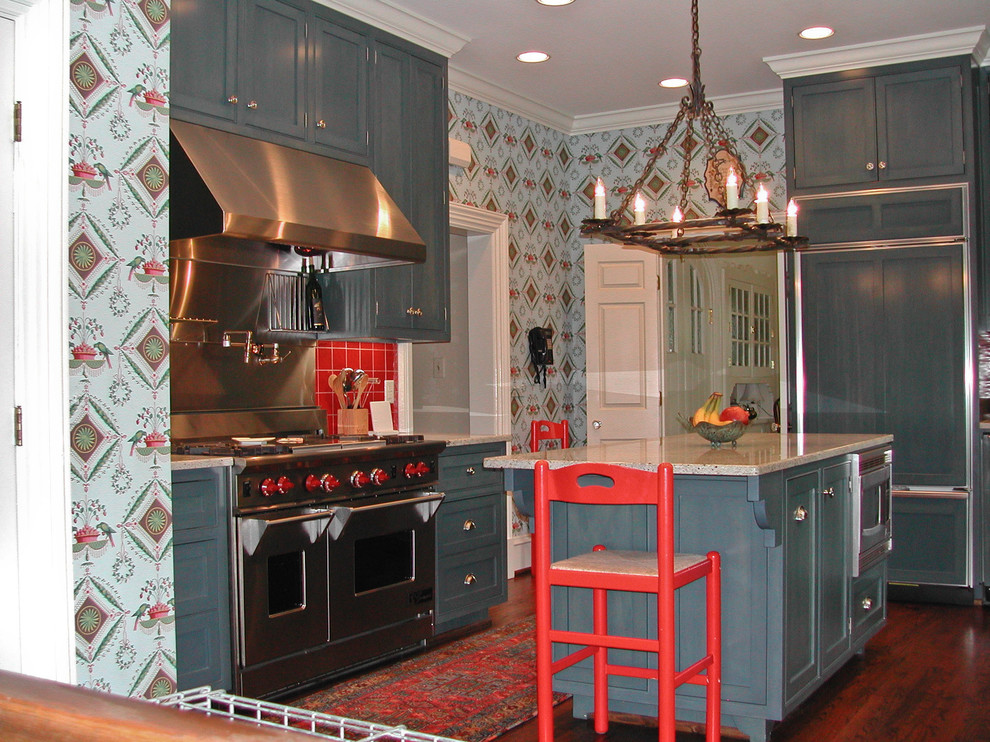 Example of a mid-sized eclectic u-shaped dark wood floor and brown floor enclosed kitchen design in Birmingham with shaker cabinets, blue cabinets, terrazzo countertops, red backsplash, ceramic backsplash, stainless steel appliances and an island