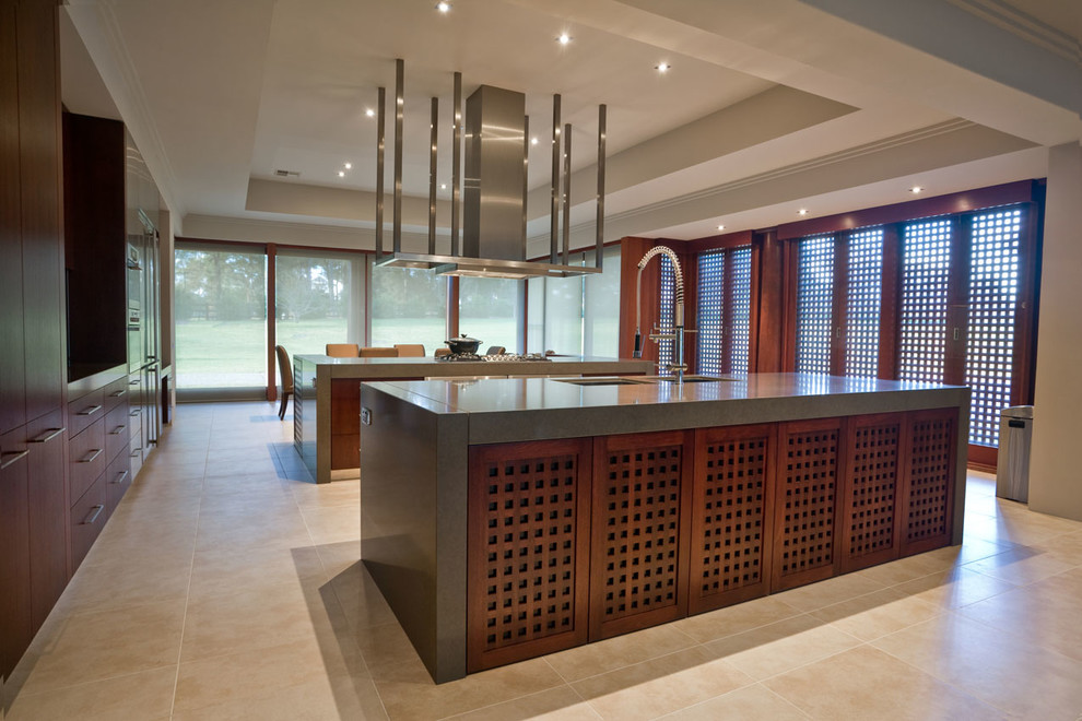 Photo of an expansive modern kitchen/diner in Sydney with a submerged sink, flat-panel cabinets, dark wood cabinets, engineered stone countertops, stainless steel appliances, travertine flooring and multiple islands.