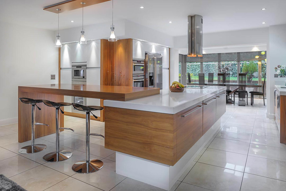 Inspiration for a large contemporary kitchen/diner in Other with flat-panel cabinets, medium wood cabinets, stainless steel appliances and a breakfast bar.