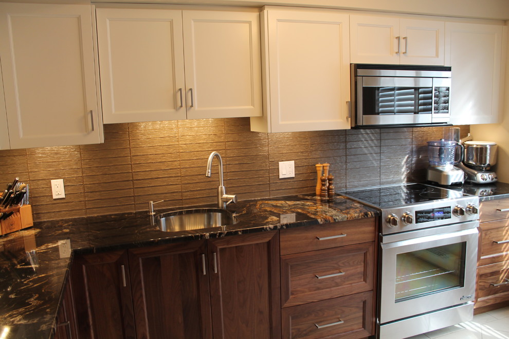 Photo of a medium sized classic l-shaped enclosed kitchen in Ottawa with a submerged sink, recessed-panel cabinets, medium wood cabinets, granite worktops, beige splashback, glass tiled splashback, stainless steel appliances and marble flooring.