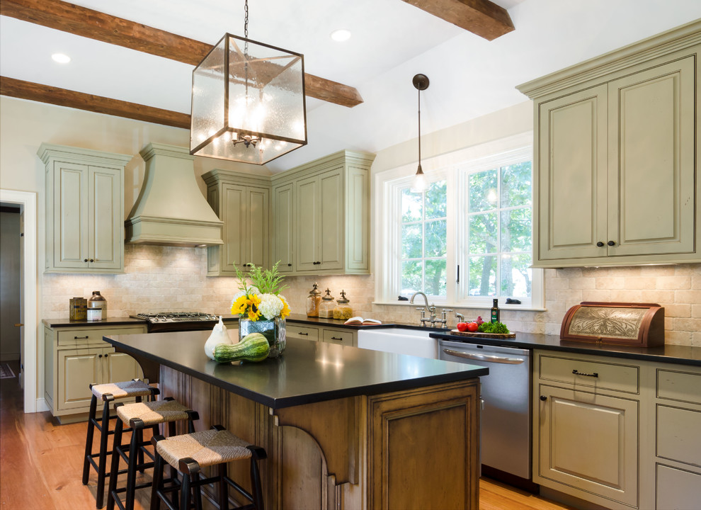 Inspiration for a mid-sized country l-shaped medium tone wood floor and orange floor enclosed kitchen remodel in Boston with a farmhouse sink, beaded inset cabinets, distressed cabinets, granite countertops, beige backsplash, marble backsplash, stainless steel appliances and an island