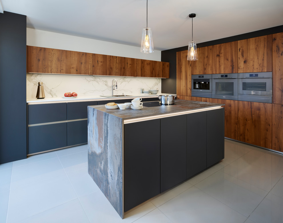 This is an example of a medium sized contemporary kitchen in Essex with an island, flat-panel cabinets, dark wood cabinets, white splashback, stone slab splashback and multicoloured worktops.