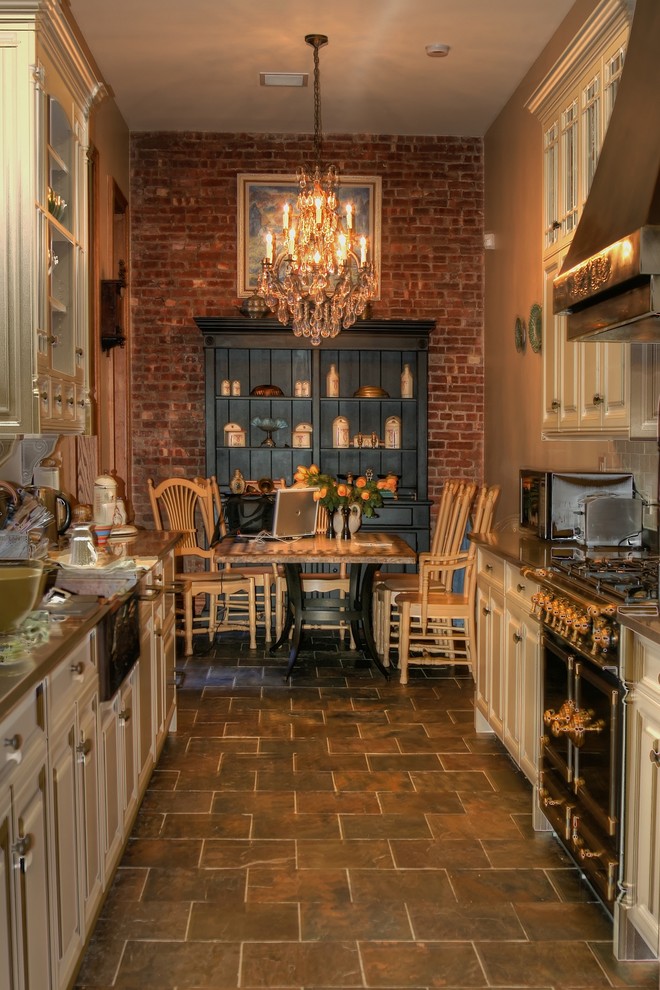 Geschlossene Klassische Küche mit profilierten Schrankfronten, beigen Schränken und schwarzen Elektrogeräten in New York