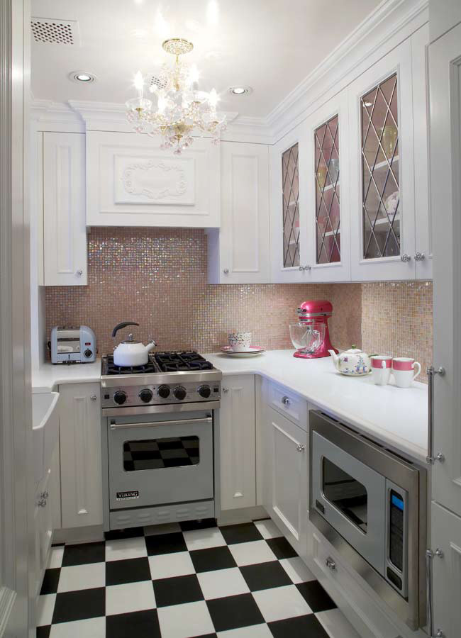 Small eclectic u-shaped ceramic tile and multicolored floor enclosed kitchen photo in New York with a farmhouse sink, recessed-panel cabinets, white cabinets, quartz countertops, pink backsplash, mosaic tile backsplash, stainless steel appliances, no island and white countertops