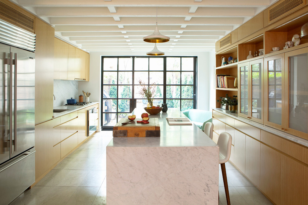 Example of a trendy galley white floor eat-in kitchen design in New York with an undermount sink, flat-panel cabinets, light wood cabinets, white backsplash, stainless steel appliances, an island and white countertops