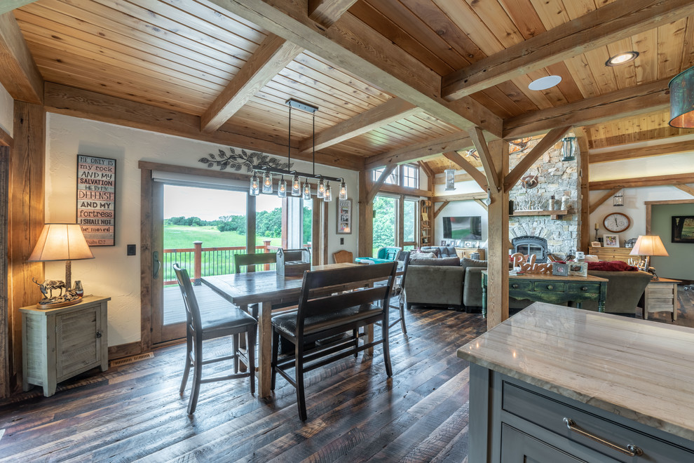Inspiration for a mid-sized rustic u-shaped dark wood floor and brown floor eat-in kitchen remodel in Milwaukee with a farmhouse sink, beaded inset cabinets, distressed cabinets, quartzite countertops, brown backsplash, ceramic backsplash, paneled appliances, an island and gray countertops