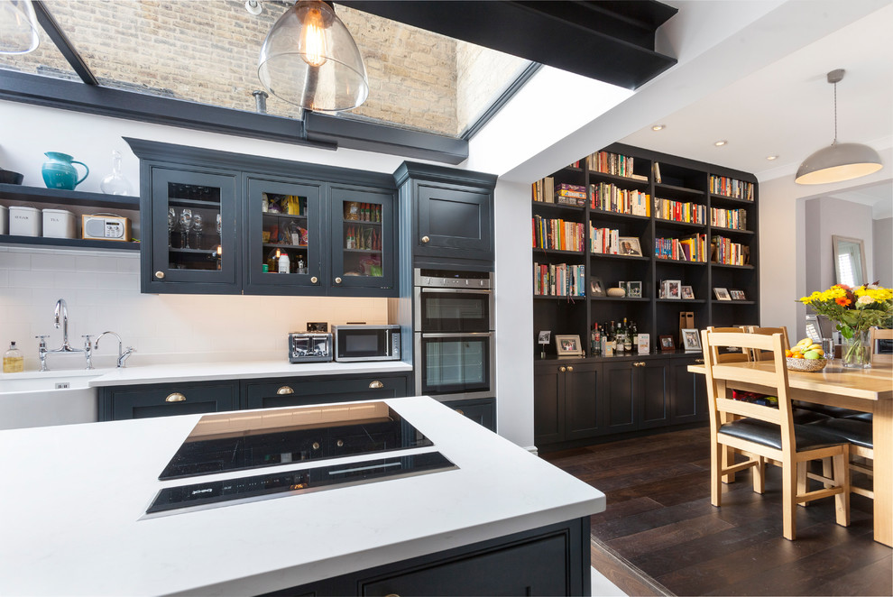 Inspiration for a classic kitchen in London with recessed-panel cabinets and an island.