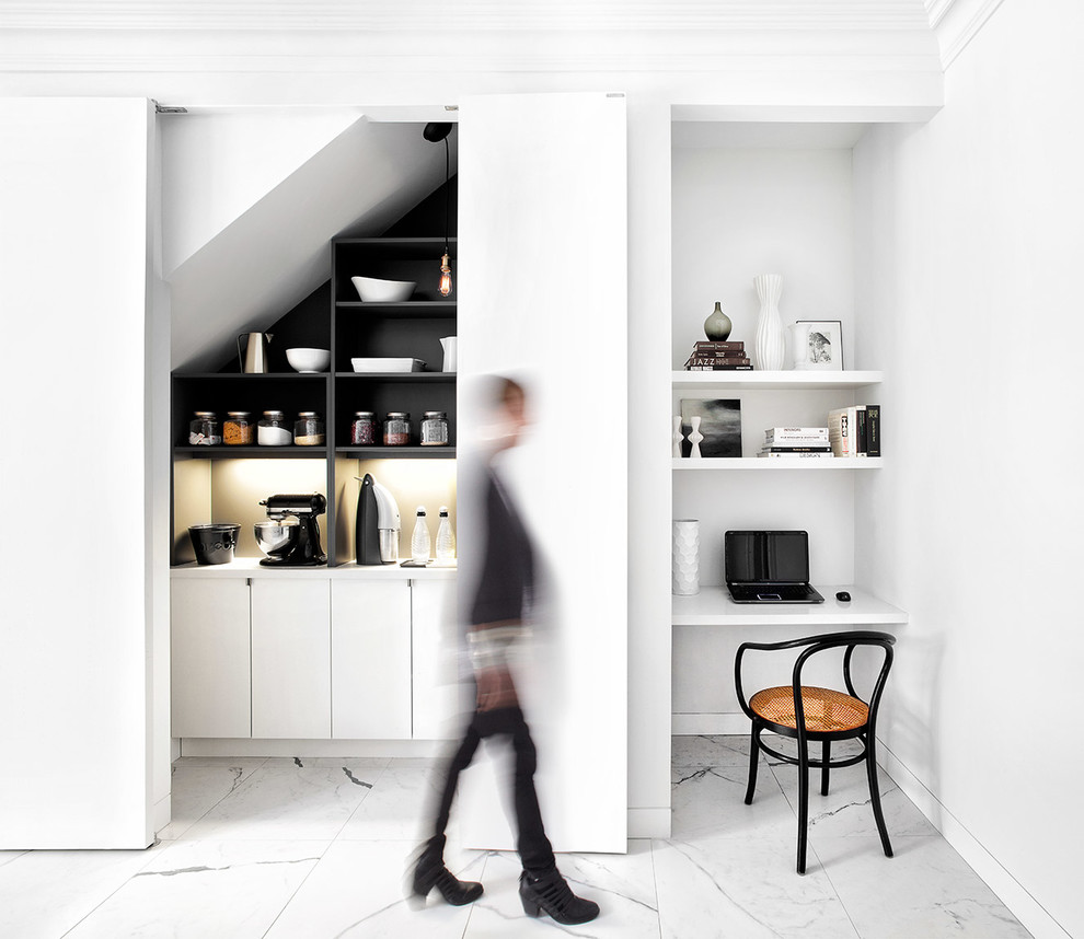 Photo of a large contemporary single-wall kitchen pantry in Toronto with a submerged sink, flat-panel cabinets, white cabinets, engineered stone countertops, white splashback, stone slab splashback, stainless steel appliances, porcelain flooring and an island.