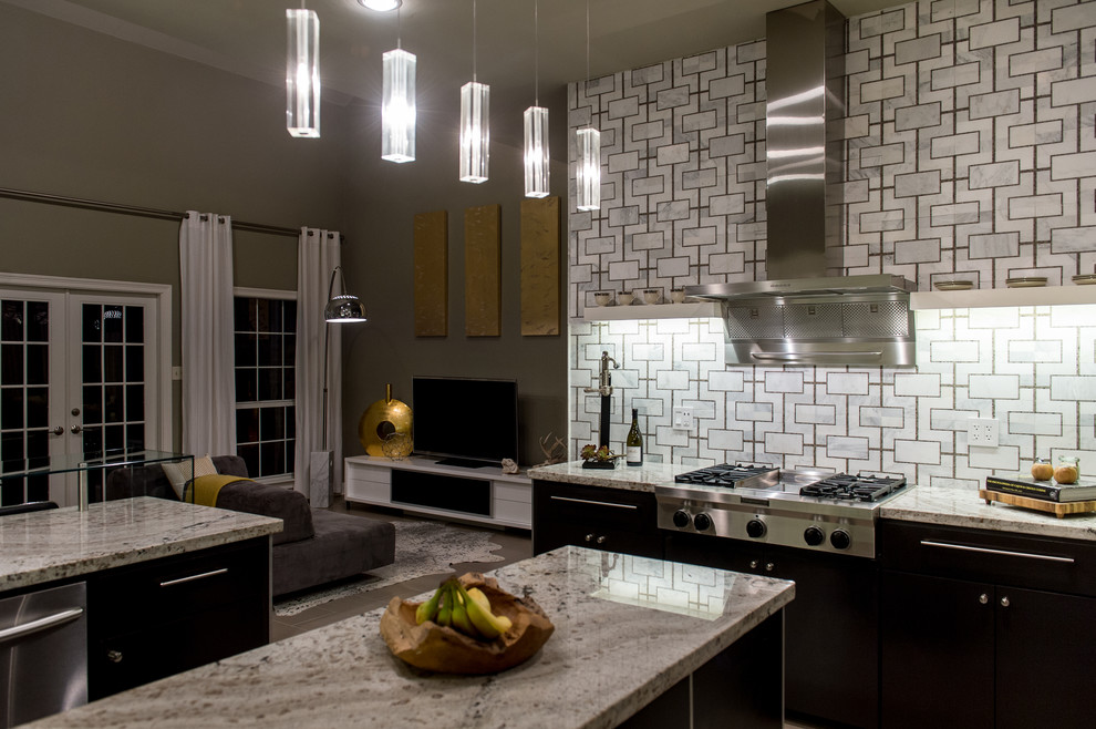 Eat-in kitchen - mid-sized contemporary u-shaped limestone floor eat-in kitchen idea in New Orleans with an integrated sink, flat-panel cabinets, black cabinets, granite countertops, multicolored backsplash, stainless steel appliances and an island
