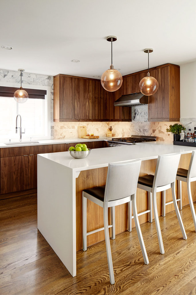 This is an example of a contemporary u-shaped kitchen in Seattle with a submerged sink, flat-panel cabinets, quartz worktops, marble splashback, integrated appliances, medium hardwood flooring, a breakfast bar, dark wood cabinets, multi-coloured splashback and beige floors.