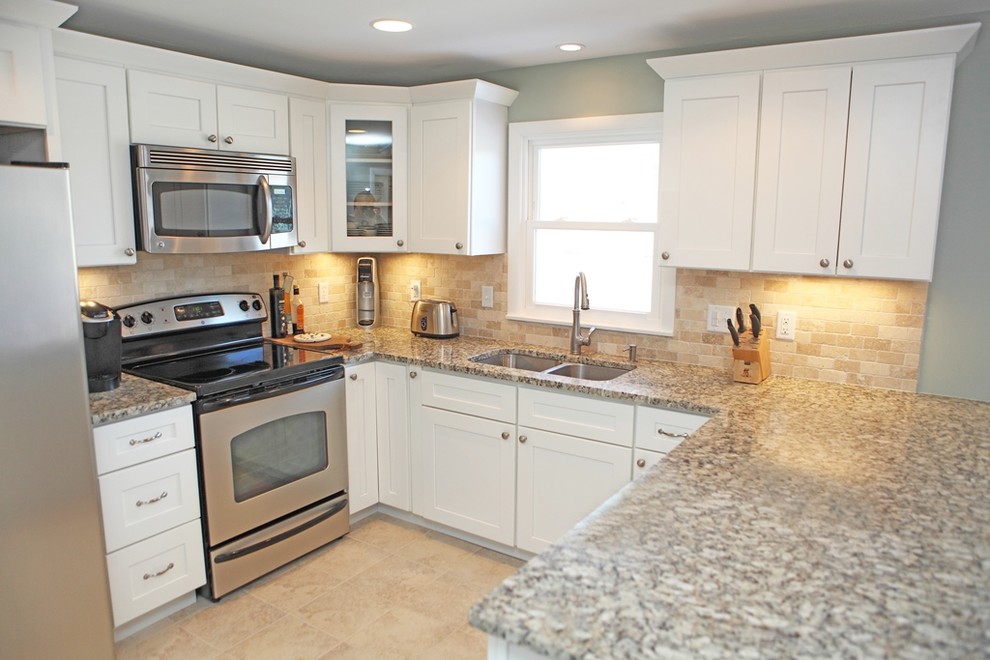Example of a mid-sized minimalist u-shaped ceramic tile eat-in kitchen design in Providence with a double-bowl sink, shaker cabinets, white cabinets, granite countertops, beige backsplash, terra-cotta backsplash and stainless steel appliances