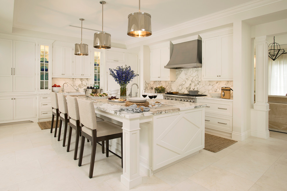 Photo of a medium sized classic l-shaped kitchen in Miami with beaded cabinets, white cabinets, stainless steel appliances, an island, white splashback and stone slab splashback.