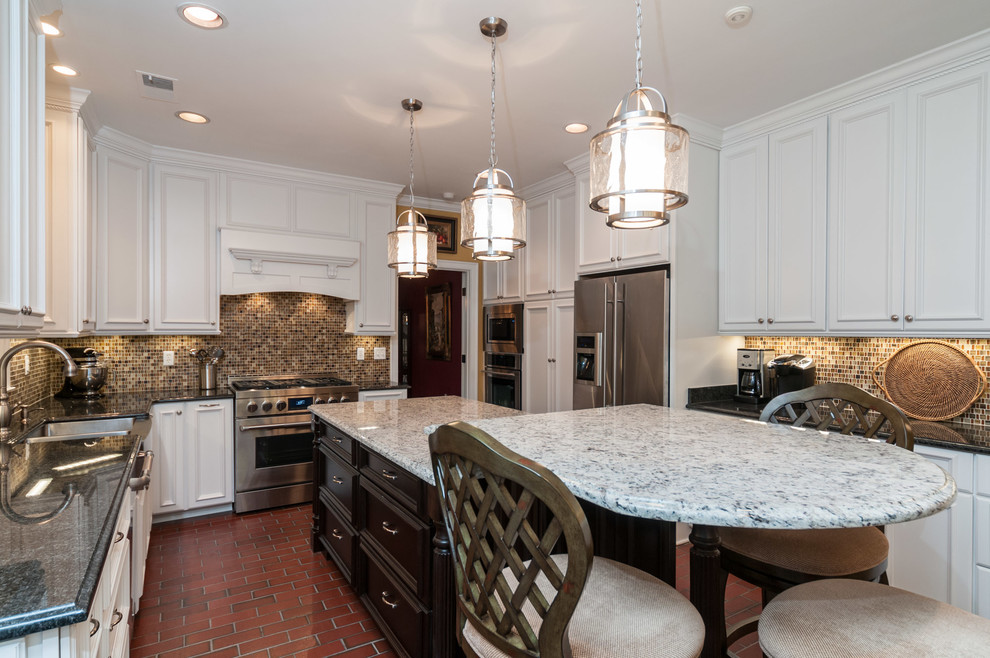 Eat-in kitchen - large traditional u-shaped brick floor eat-in kitchen idea in Other with a farmhouse sink, recessed-panel cabinets, white cabinets, quartz countertops, multicolored backsplash, mosaic tile backsplash, stainless steel appliances and an island