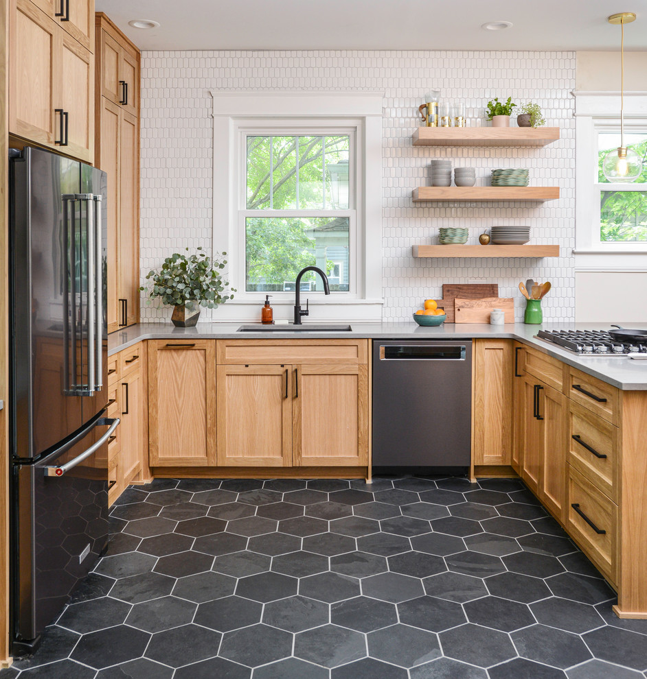 Transitional u-shaped gray floor eat-in kitchen photo in Nashville with an undermount sink, shaker cabinets, medium tone wood cabinets, white backsplash, black appliances, a peninsula and gray countertops