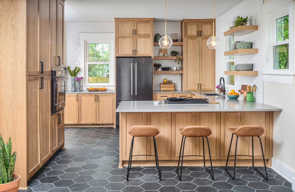 Gray floor kitchen photo in Nashville with light wood cabinets, white backsplash, ceramic backsplash and gray countertops