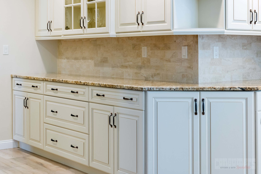 Mid-sized galley plywood floor and beige floor eat-in kitchen photo in New York with an undermount sink, raised-panel cabinets, white cabinets, granite countertops, beige backsplash, stainless steel appliances and an island
