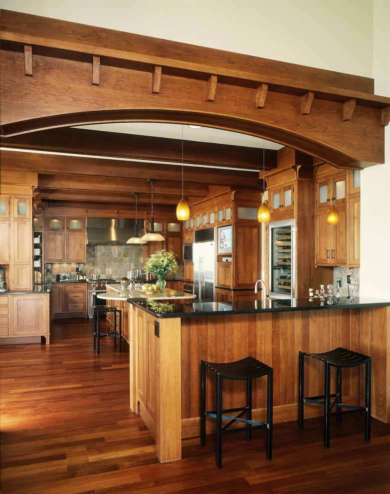 Design ideas for a classic kitchen in Detroit with shaker cabinets, medium wood cabinets, grey splashback, stainless steel appliances and slate splashback.