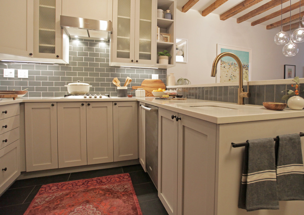Photo of a small classic u-shaped kitchen/diner in New York with a submerged sink, shaker cabinets, grey cabinets, engineered stone countertops, grey splashback, metro tiled splashback, stainless steel appliances, slate flooring and a breakfast bar.