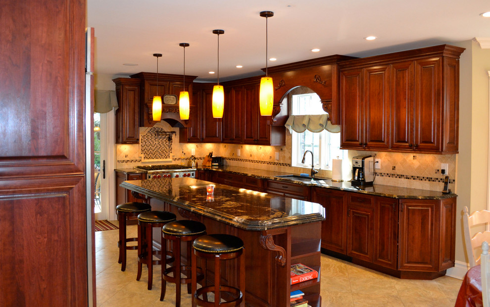 Klassisk inredning av ett mellanstort kök, med en nedsänkt diskho, luckor med upphöjd panel, skåp i mellenmörkt trä, marmorbänkskiva, flerfärgad stänkskydd, stänkskydd i glaskakel, rostfria vitvaror och en köksö