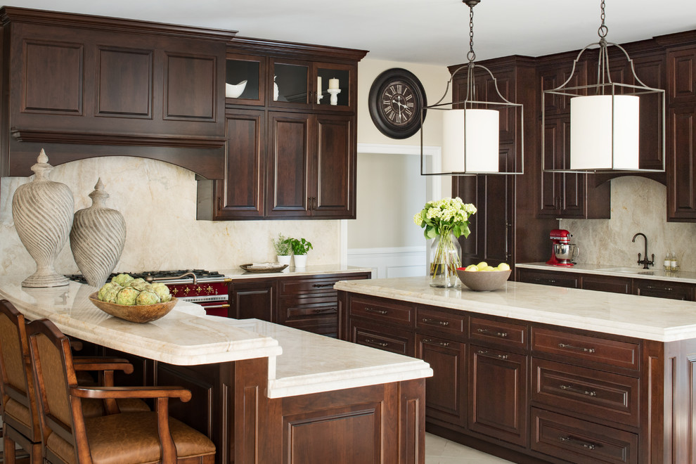 Inspiration for a timeless kitchen remodel in DC Metro with an undermount sink, raised-panel cabinets, dark wood cabinets, beige backsplash, two islands and beige countertops