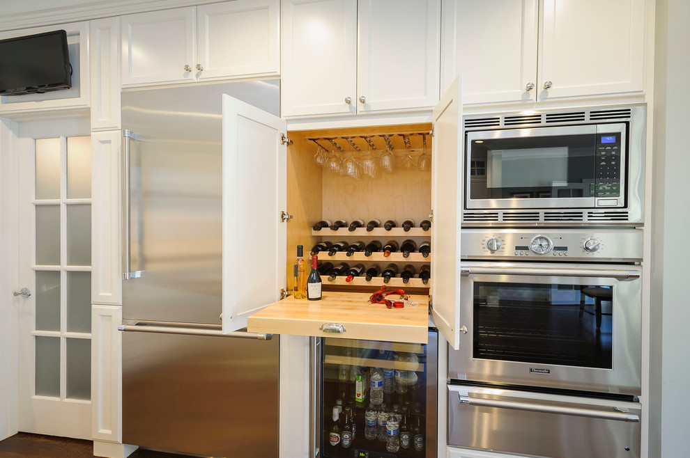 Kitchen - large country medium tone wood floor and brown floor kitchen idea in San Francisco with white cabinets, stainless steel appliances and recessed-panel cabinets