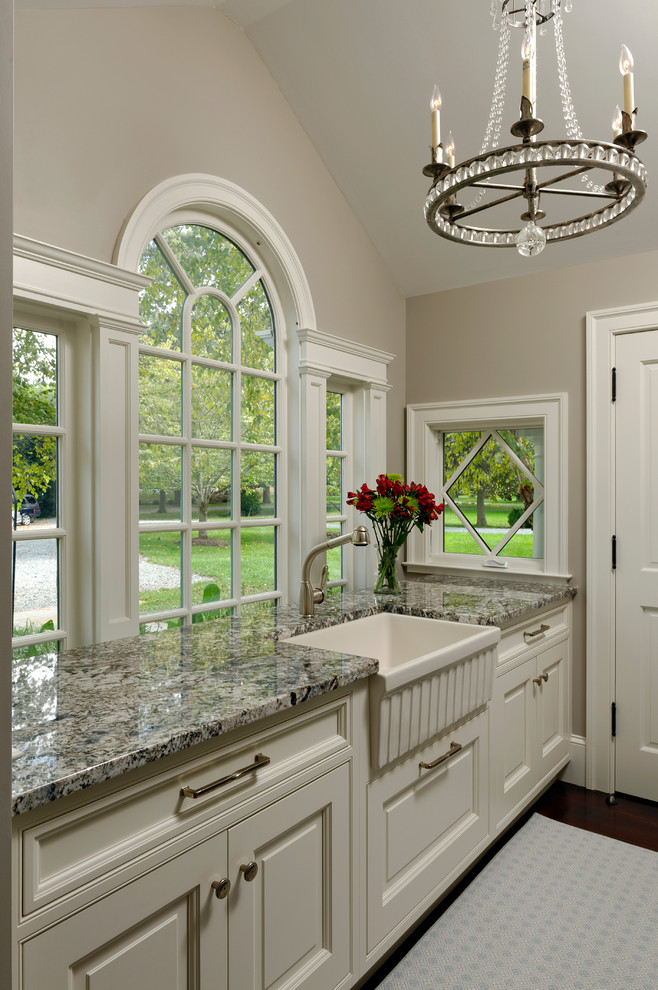 Example of a large classic dark wood floor eat-in kitchen design in Baltimore with a farmhouse sink, beaded inset cabinets, white cabinets, granite countertops, white backsplash, subway tile backsplash, stainless steel appliances and an island