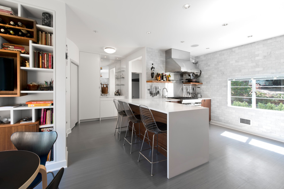 Eat-in kitchen - contemporary l-shaped eat-in kitchen idea with an undermount sink, flat-panel cabinets, dark wood cabinets, quartz countertops, white backsplash, stone tile backsplash and stainless steel appliances