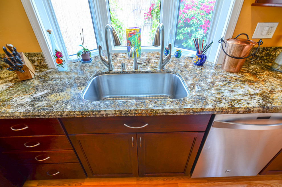 Example of a large trendy galley medium tone wood floor eat-in kitchen design in Tampa with a single-bowl sink, recessed-panel cabinets, red cabinets, granite countertops, yellow backsplash, glass tile backsplash and stainless steel appliances